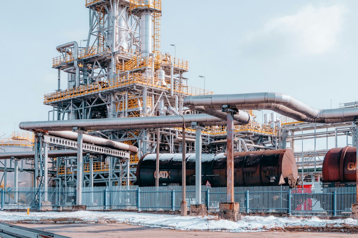 Processing plant with steel structures, pipe racks, and storage tanks.
